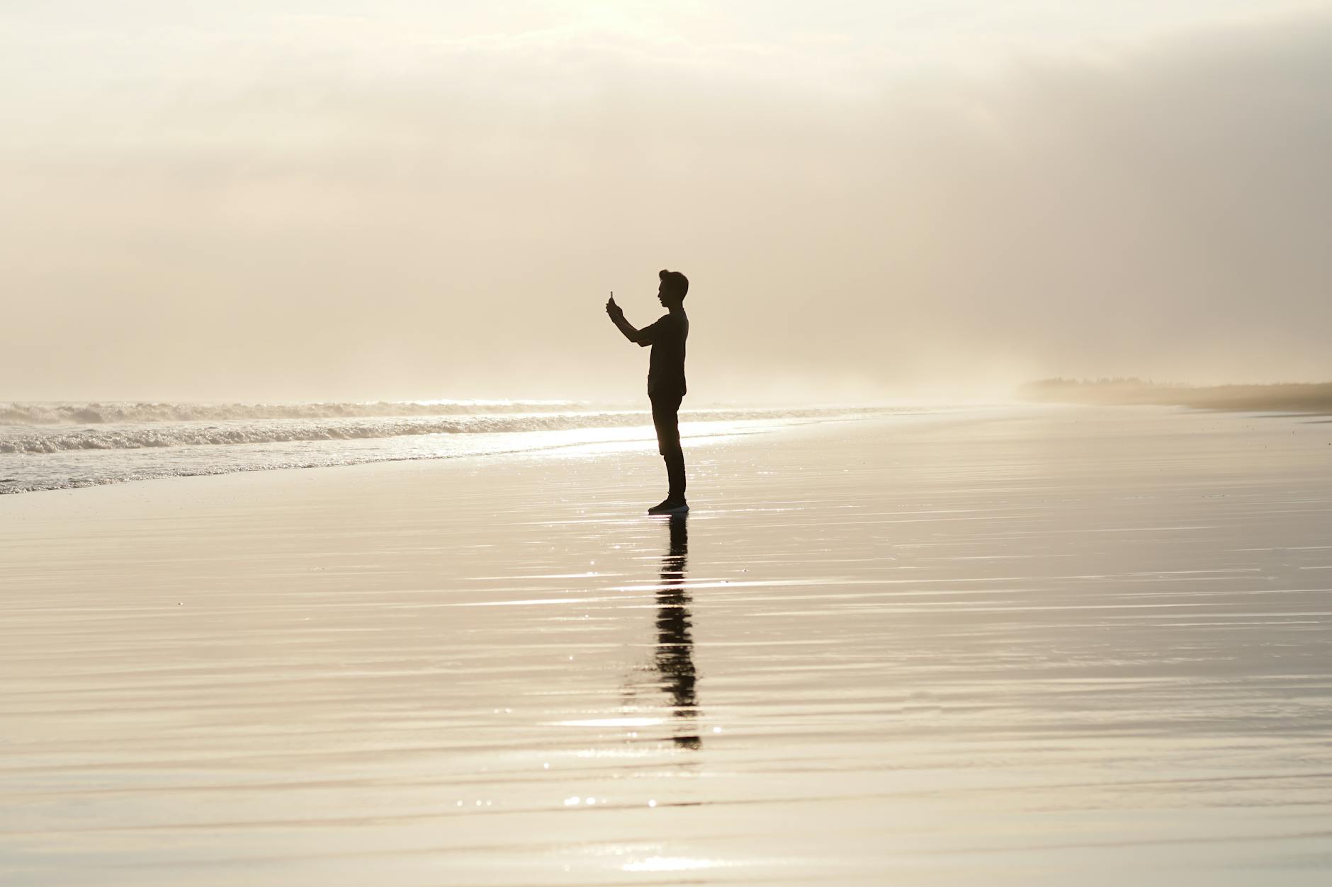 Person smiling while drinking a glass of water, symbolizing a small healthy habit.
